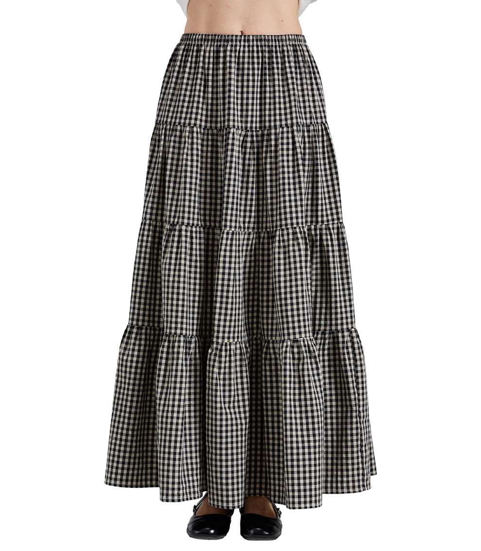 Front view of vintage black and white plaid 100% cotton maxi skirt featuring a tiered A-line silhouette and elastic high waist.