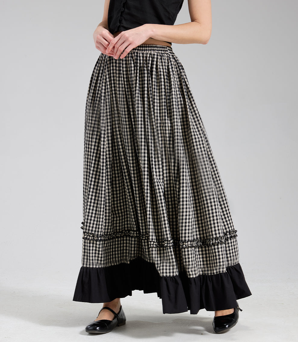 Front view of a lightweight 100% cotton black and white gingham maxi skirt, showcasing the vintage A-line silhouette and solid black ruffle hem against a plain background.