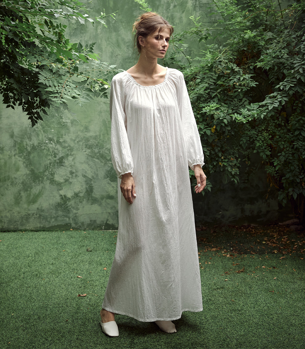 Elegant white Victorian nightgown with long sleeves and delicate lace trim