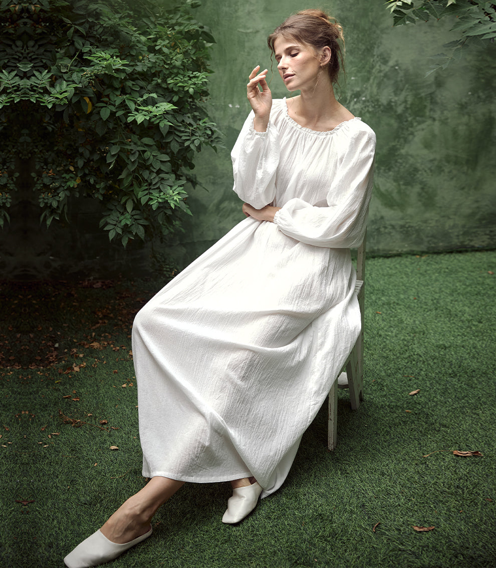 Elegant white Victorian nightgown with long sleeves and delicate lace trim