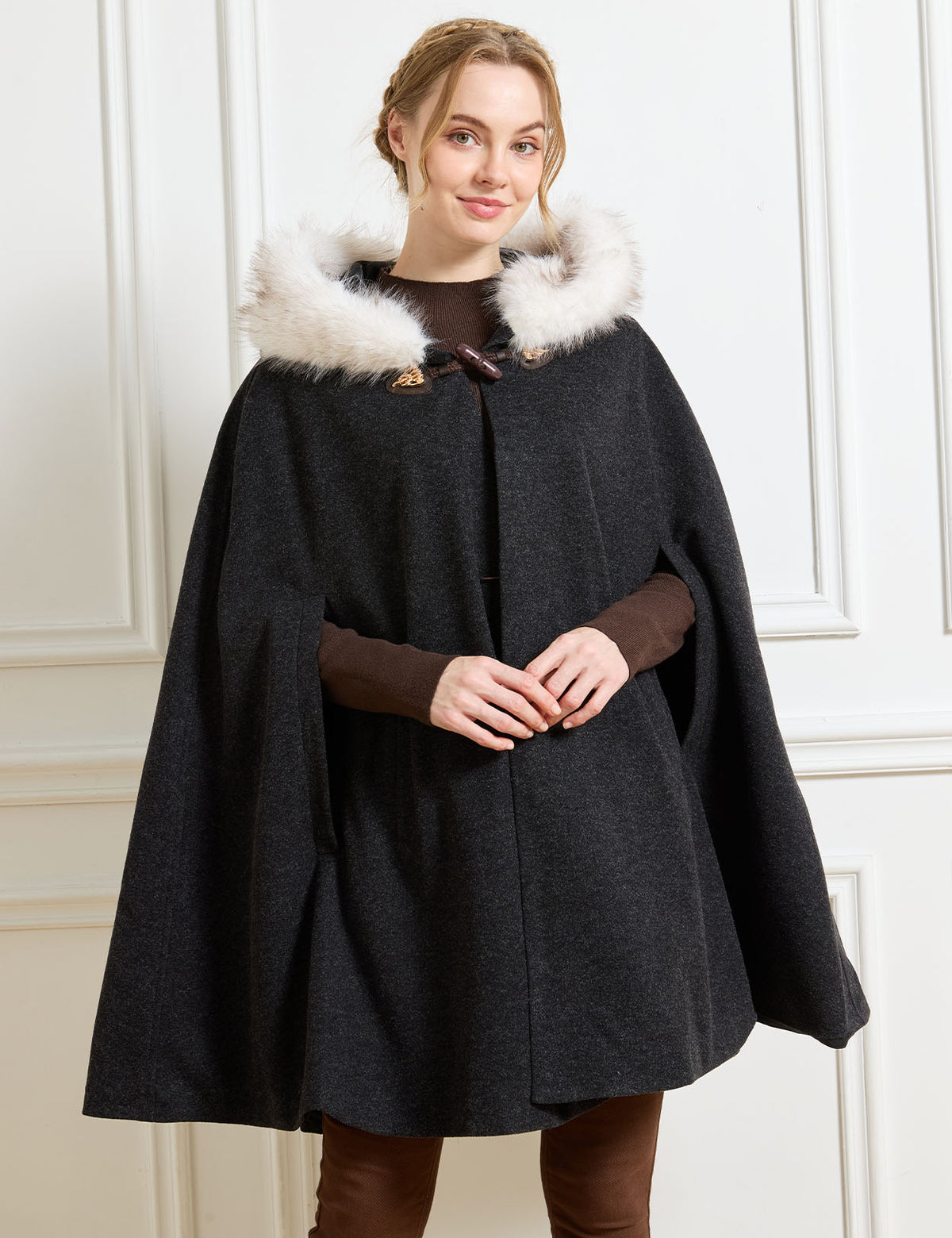 Beautelicate black winter cloak in a comfortable wool blend, featuring a faux fur hood trim and ergonomic front arm slits, perfect for an unrestrictive, vintage inspired daily look.