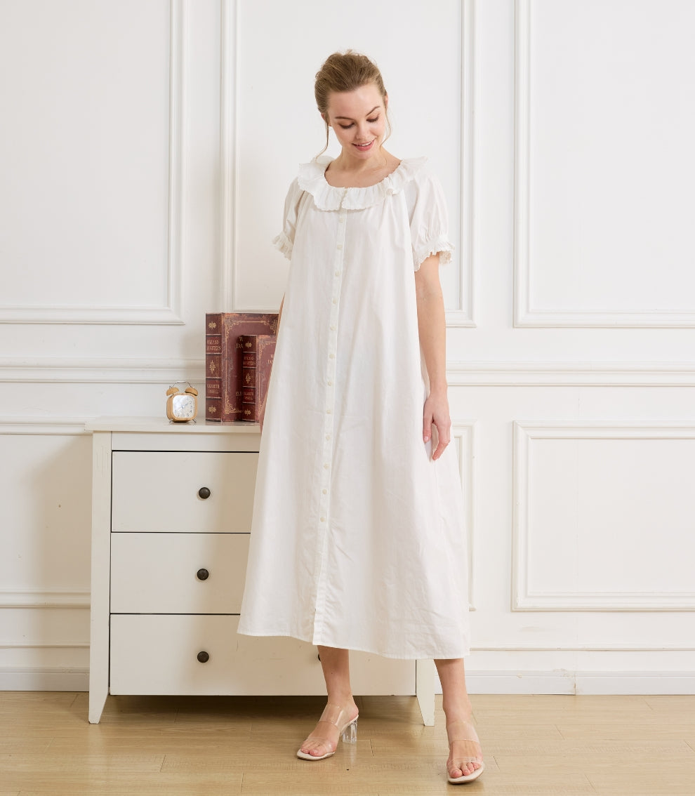 Model wearing a breezy white Beautelicate dress. Ideal summer house clothing offering a relaxed and lightweight fit.
