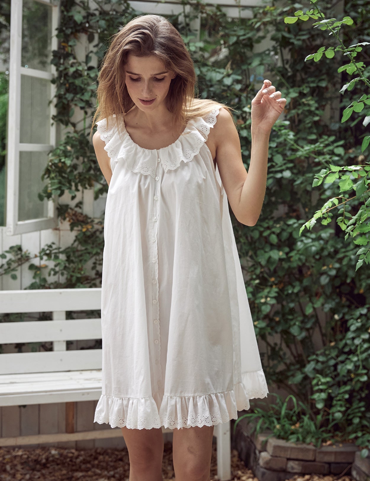 Elegant off-white Victorian style cotton nightgown with delicate ruffles and antique-inspired buttons