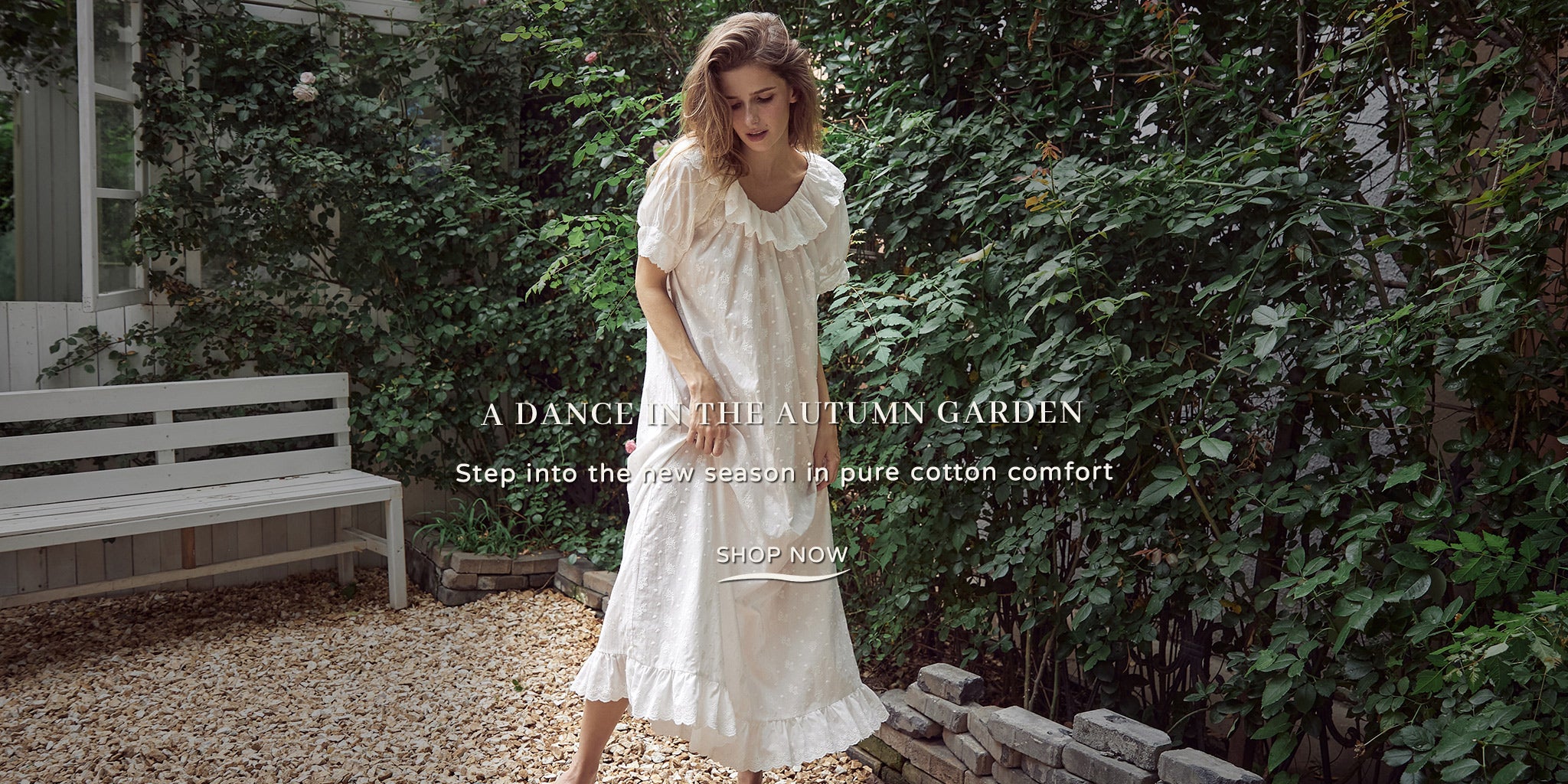 Woman wearing a Beautelicate vintage white pure cotton nightgown with a ruffled scoop neckline, short puff sleeves, and embroidered texture details.