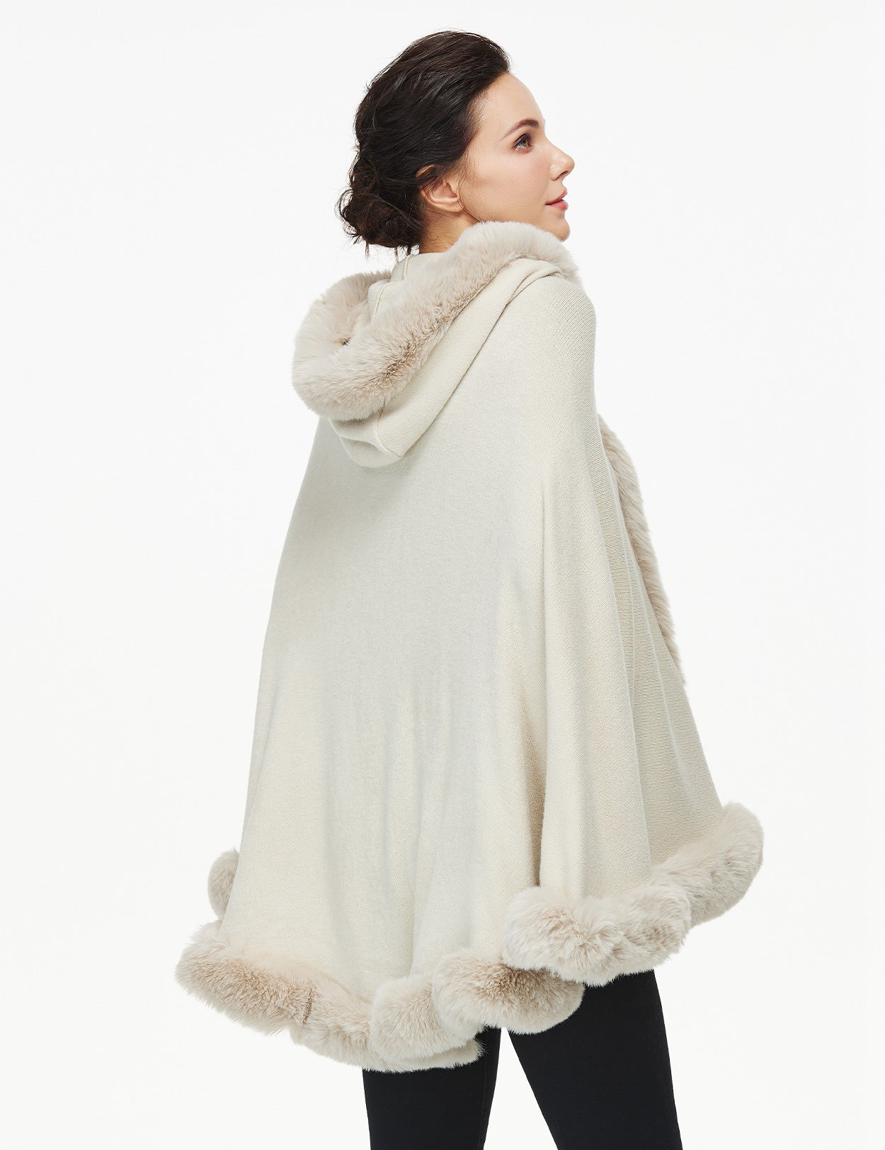 Women's faux fur poncho with hood showing elegant drape and texture