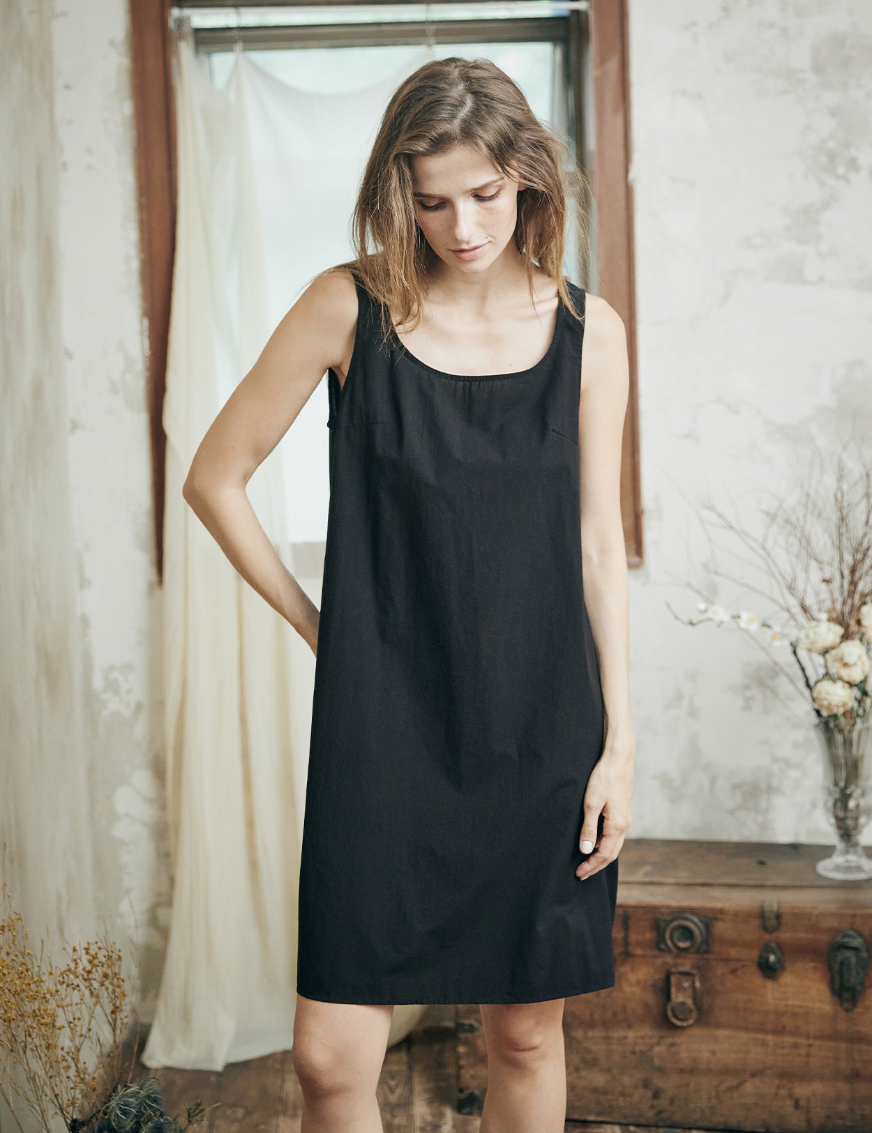 Woman wearing black cotton full slip with wide straps, showing comfortable fit and elegant design