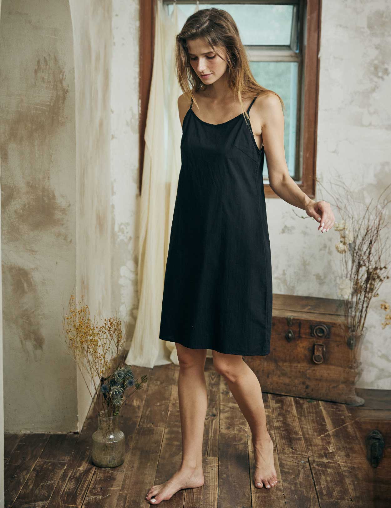 Women's cotton slip dress in black with adjustable straps and round neck