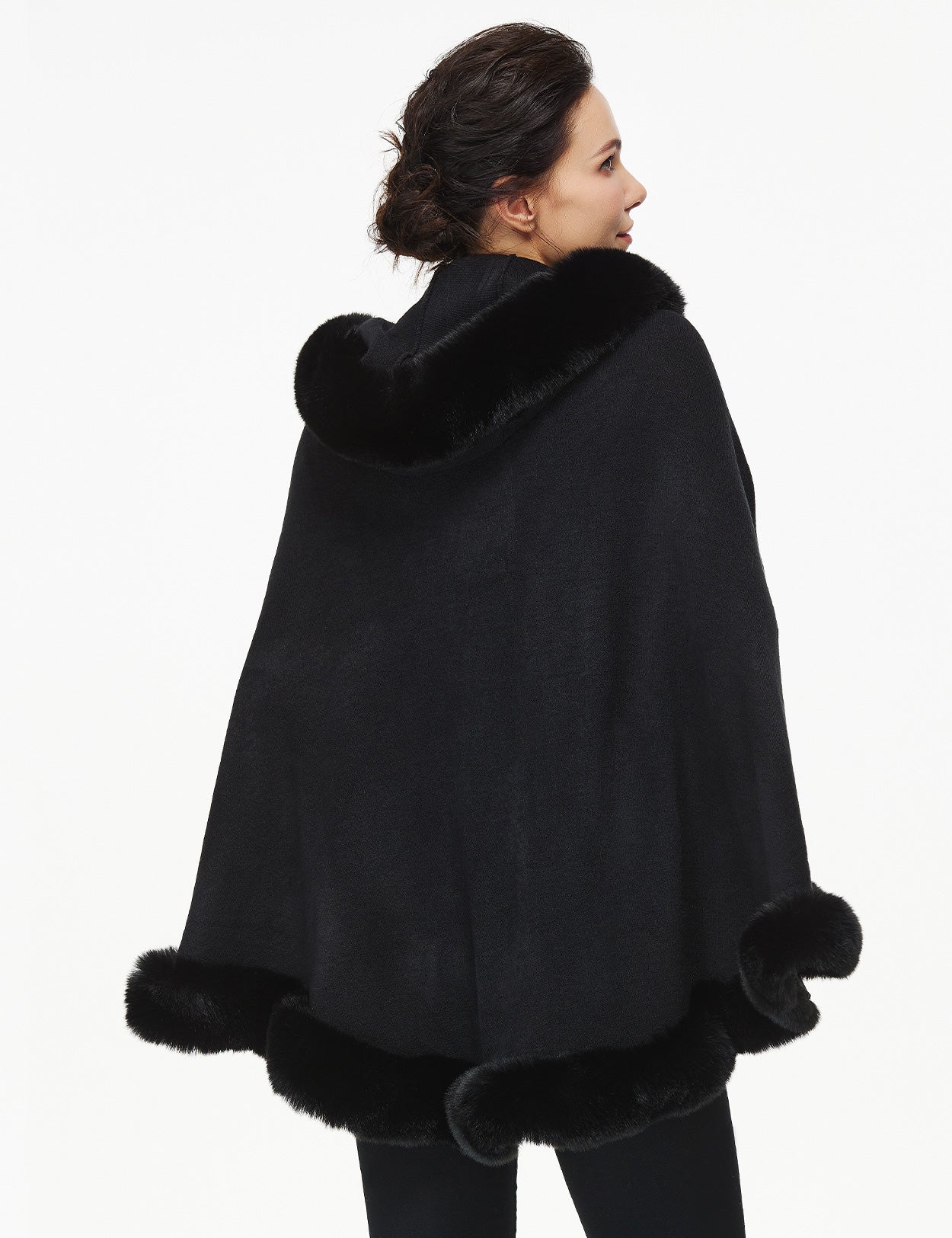 Women's faux fur poncho with hood showing elegant drape and texture