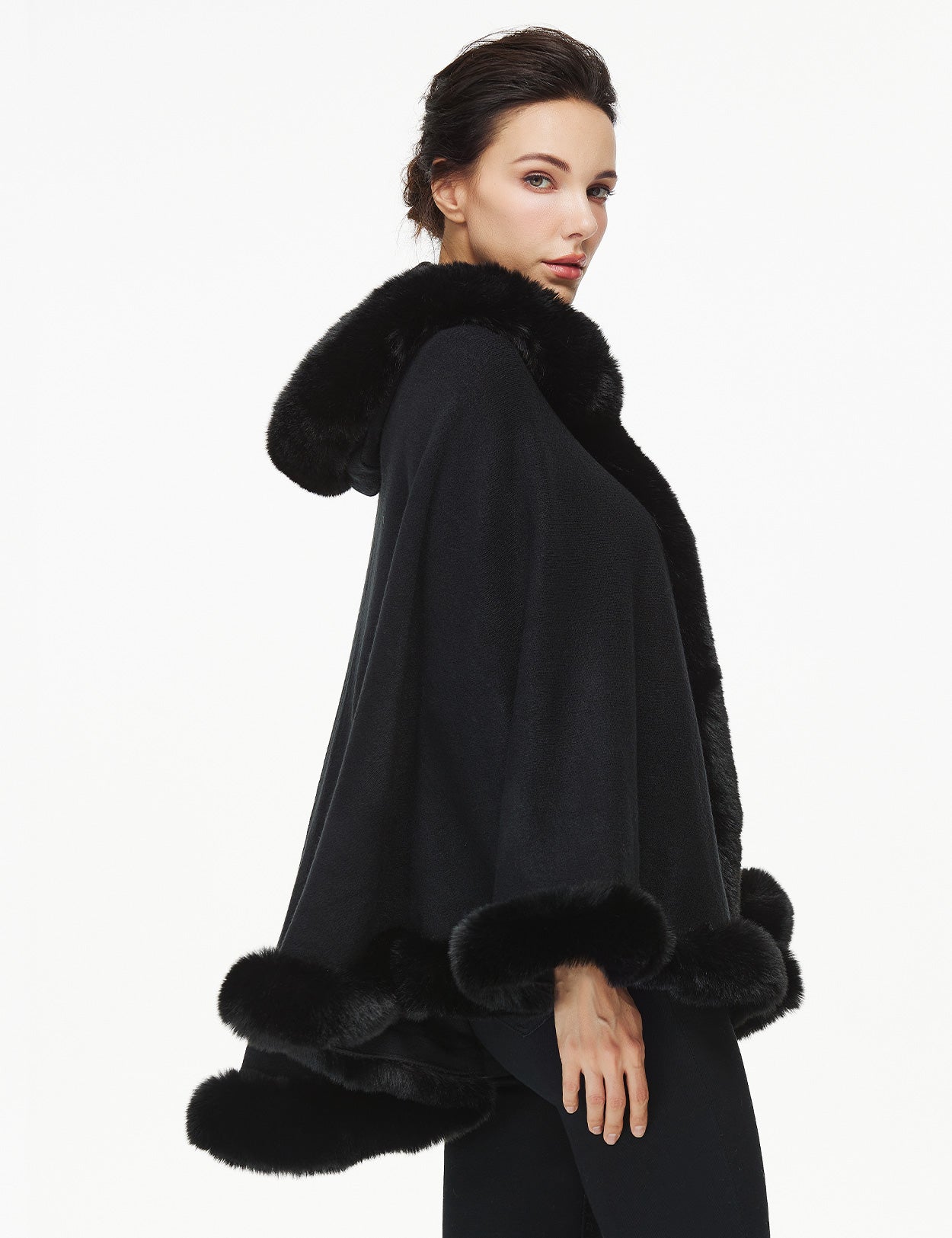 Women's faux fur poncho with hood showing elegant drape and texture