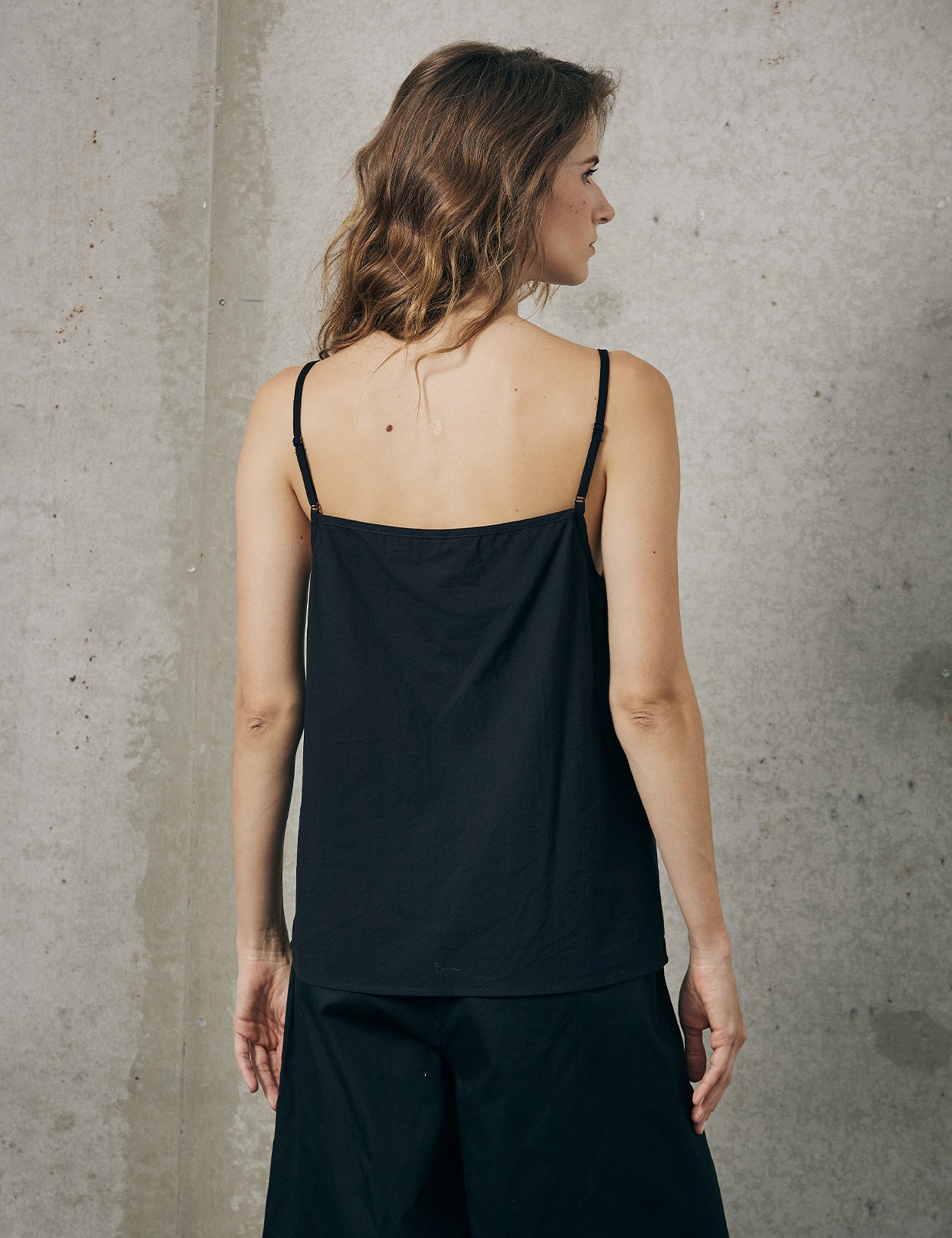 Adjustable strap 100% cotton camisole top in black - back view