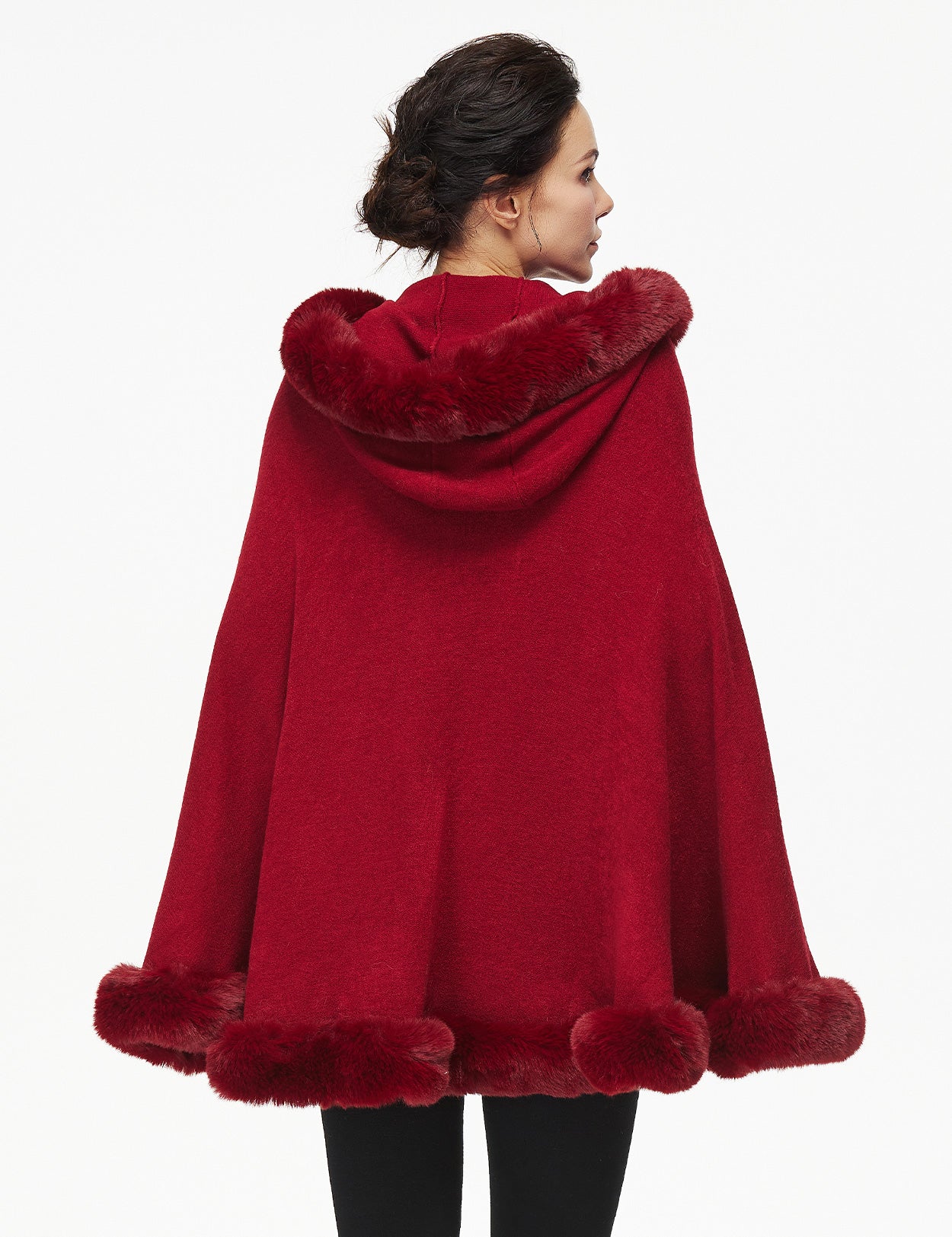 Women's faux fur poncho with hood showing elegant drape and texture