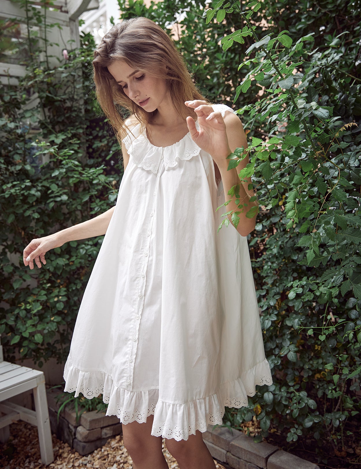 Close-up view of Victorian nightgown showing intricate ruffle details and decorative dummy buttons on cotton fabric