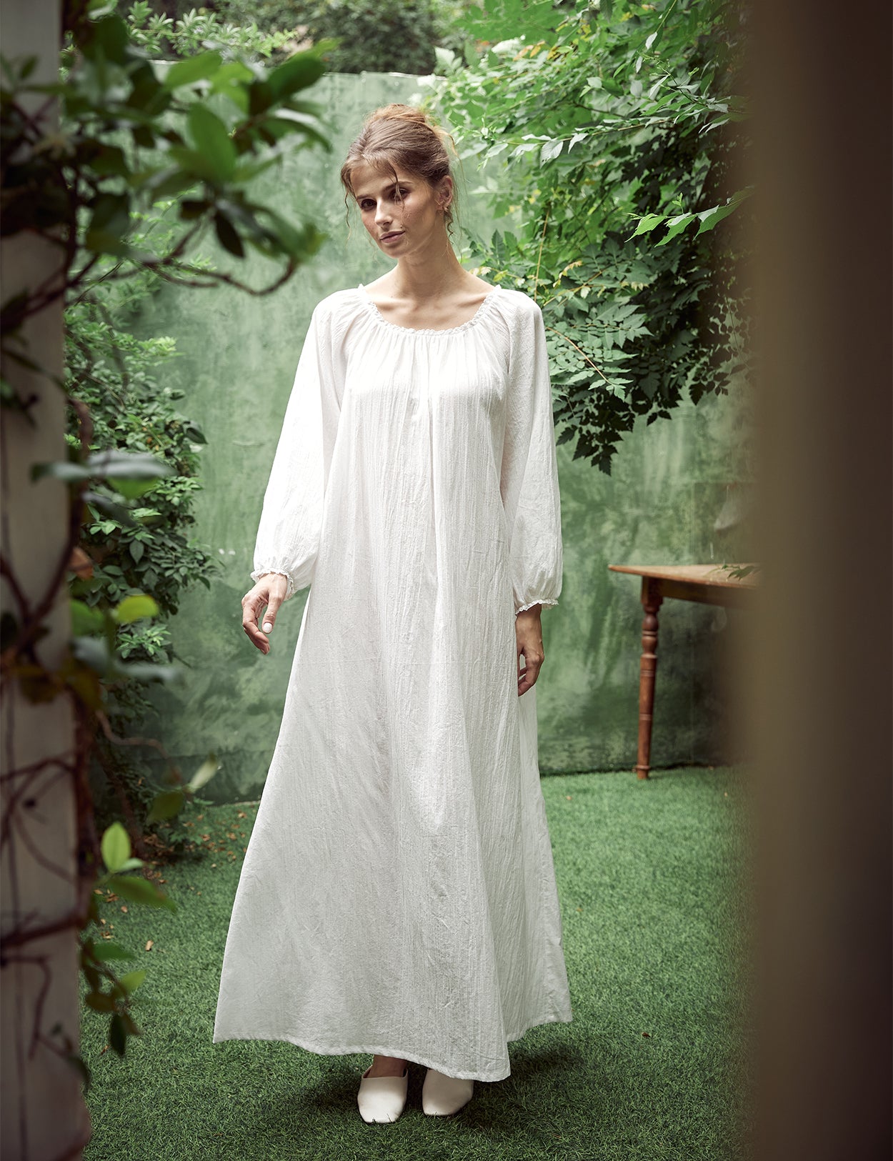 Elegant white Victorian nightgown with long sleeves and delicate lace trim