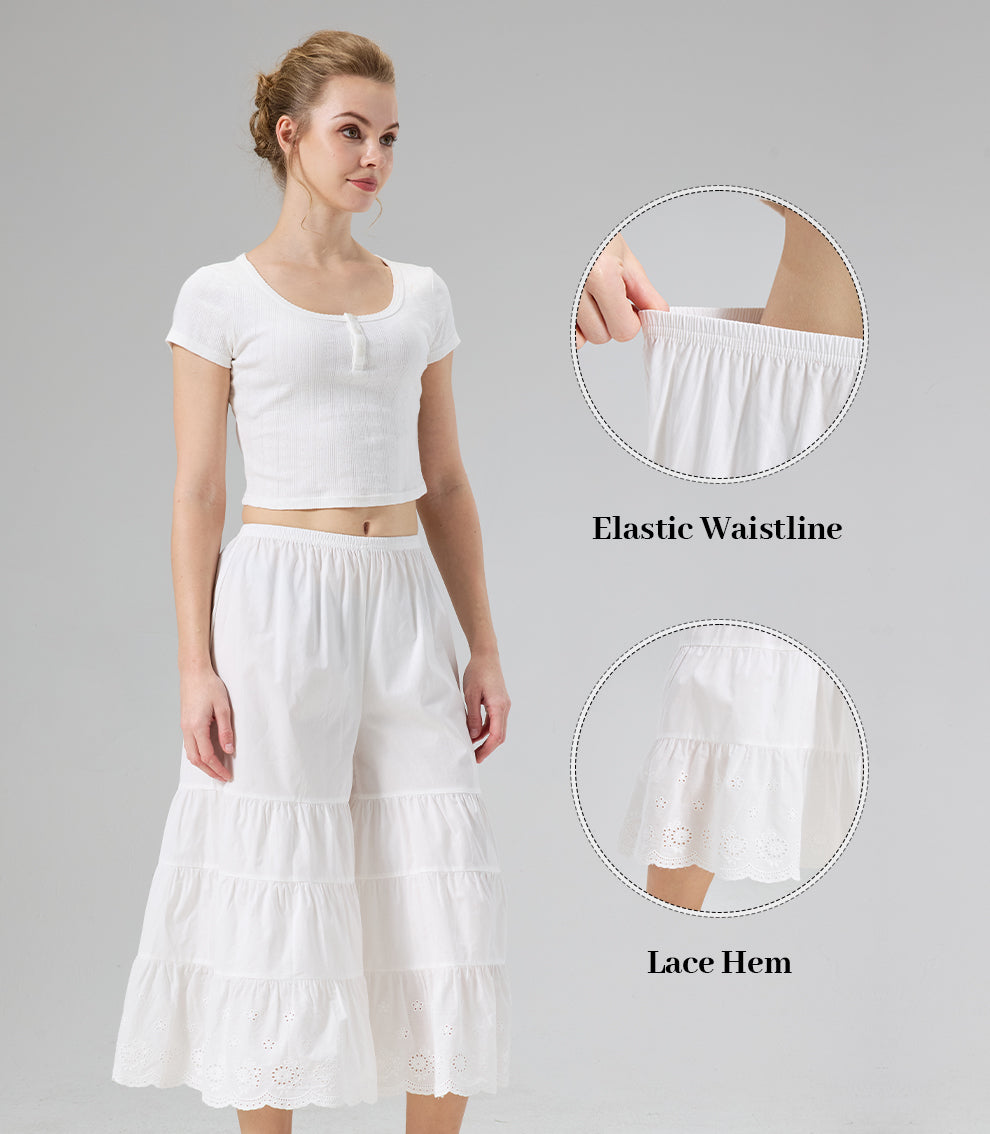 Close-up details of the comfortable elastic waistline and intricate scalloped eyelet lace hem on ivory culottes.