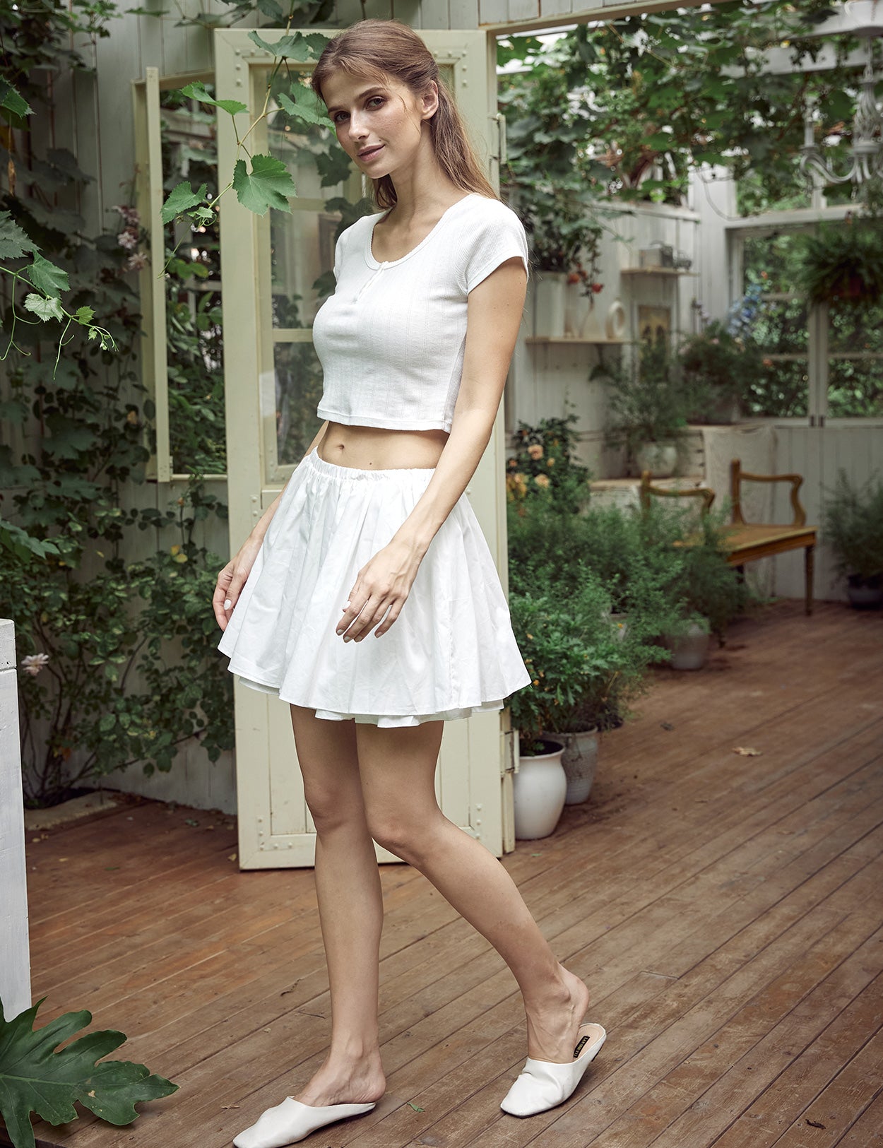 White cotton mini skirt with fluffy trim and pockets showing high-waisted A-line design
