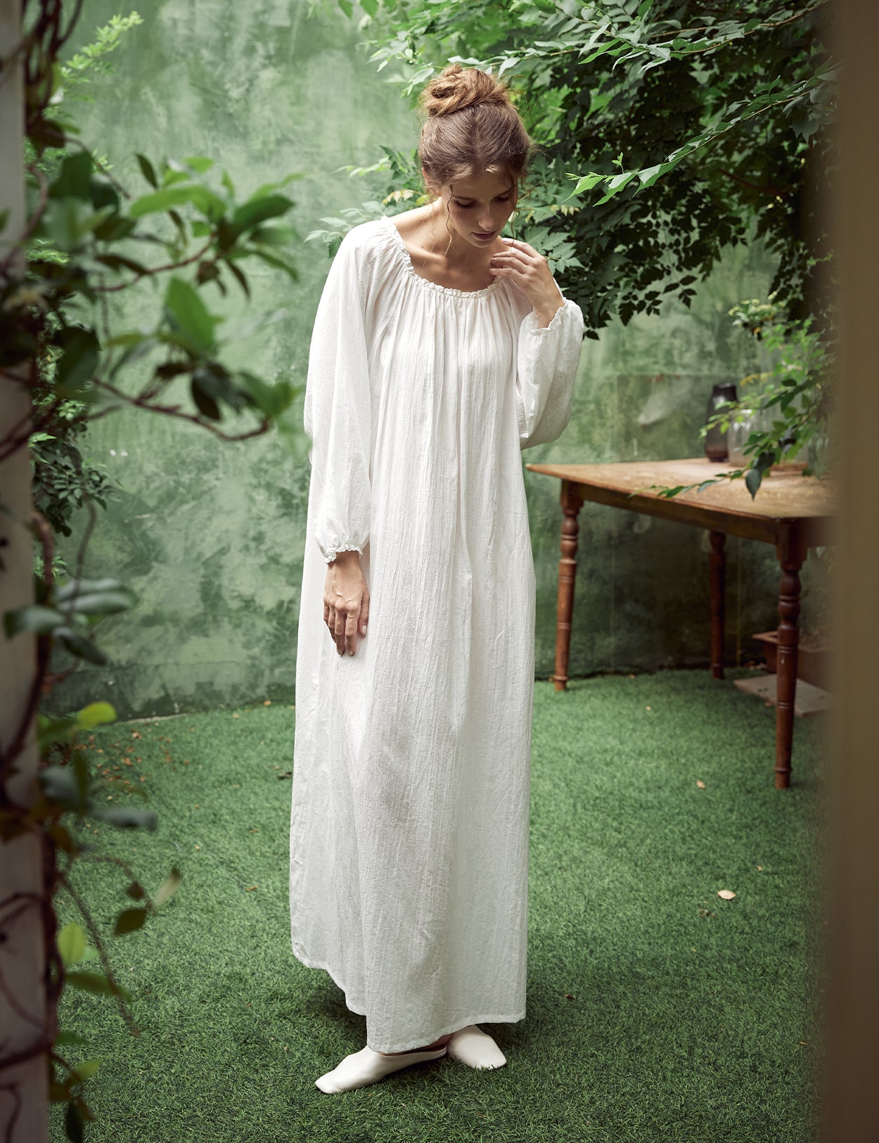 Elegant white Victorian nightgown with long sleeves and delicate lace trim