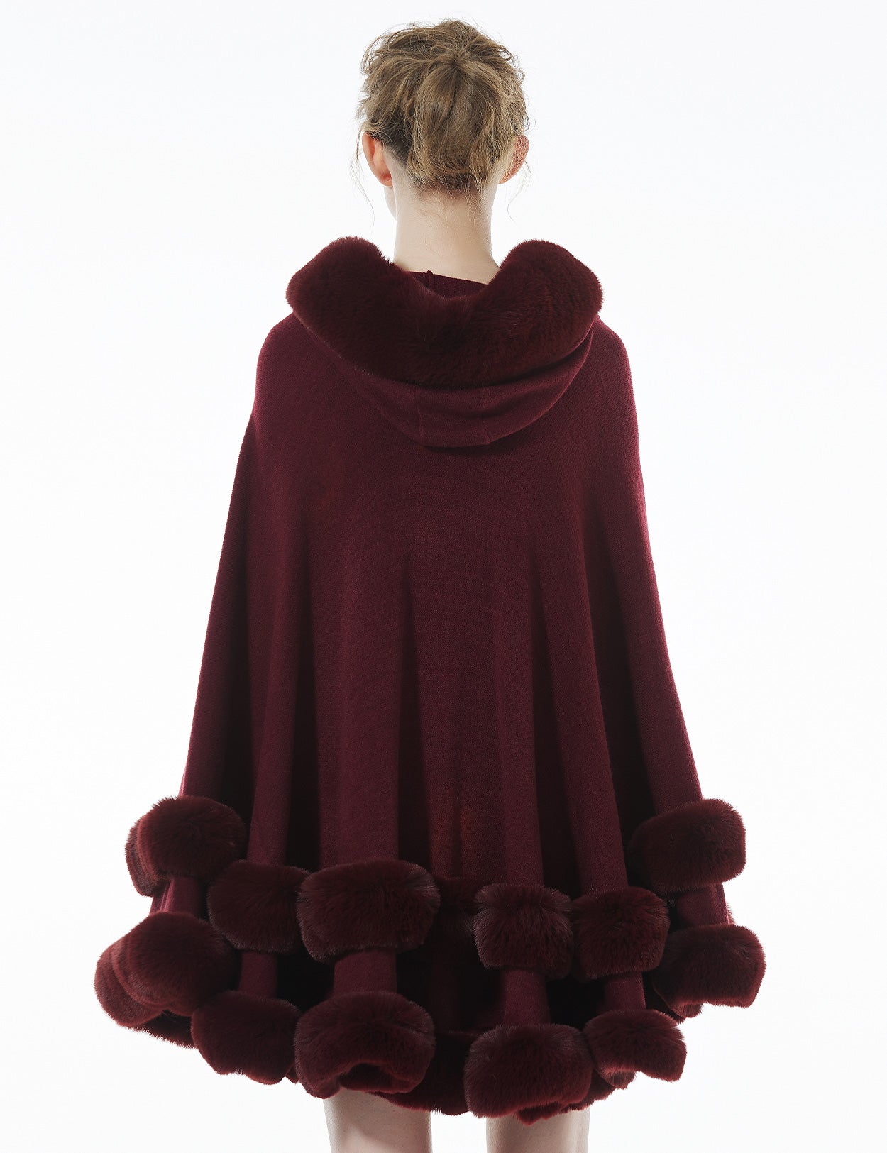 Back view of burgundy hooded knit cape highlighting rich color and flowing cape silhouette