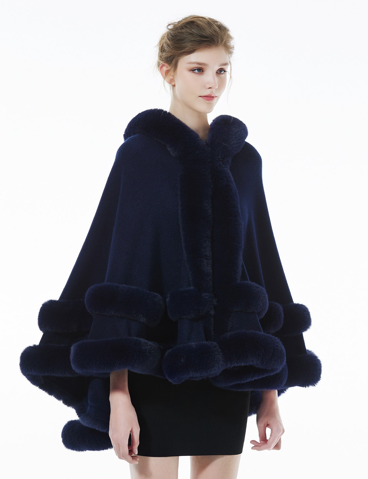 Model wearing darkblue hooded knit cape - front styling view showing elegant drape and fit
