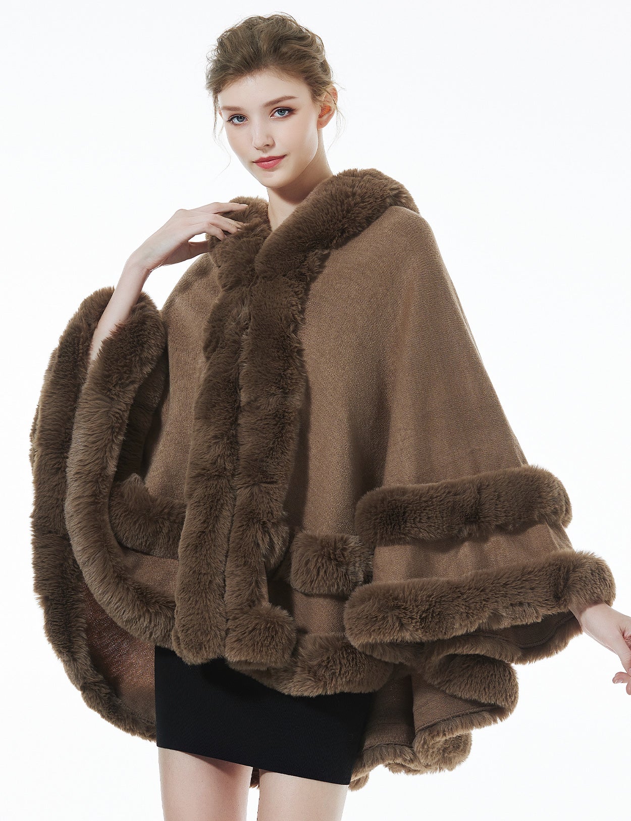 Model wearing khaki hooded knit cape - front styling view showing elegant drape and fit
