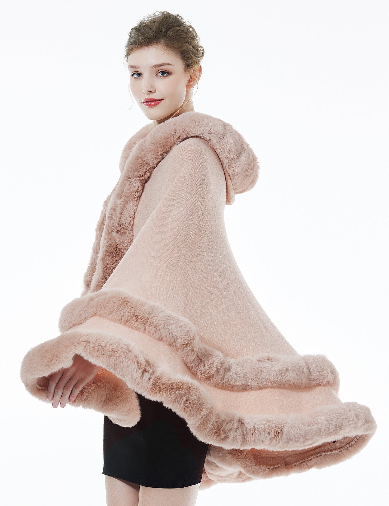 Model wearing pink hooded knit cape - front styling view showing elegant drape and fit