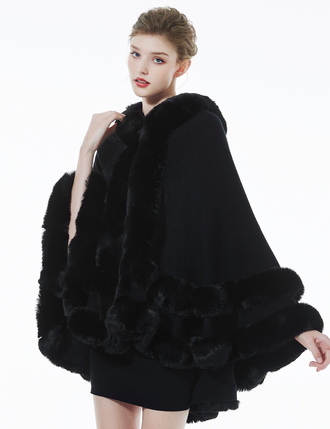 Model wearing black hooded knit cape - front view styling