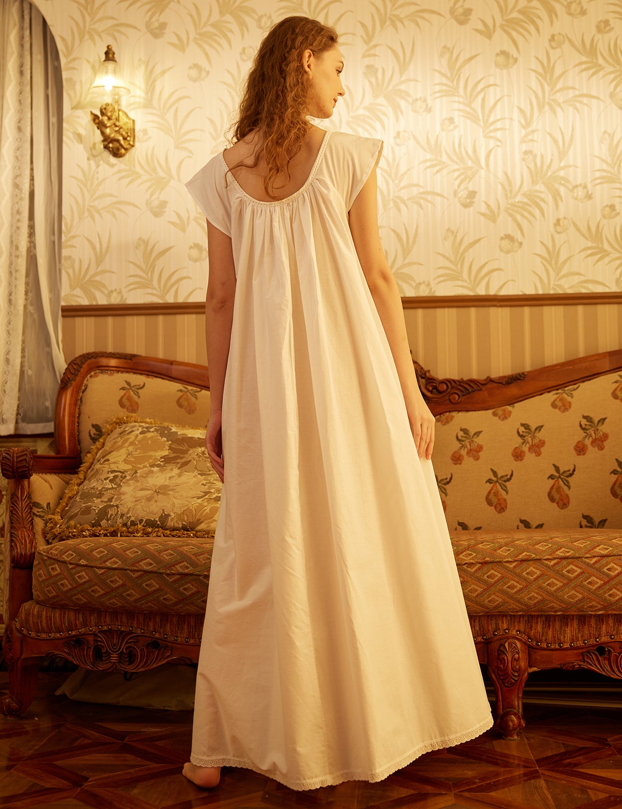 Back view of long Victorian maternity cotton nightgown showing full coverage and elegant lace hem detail