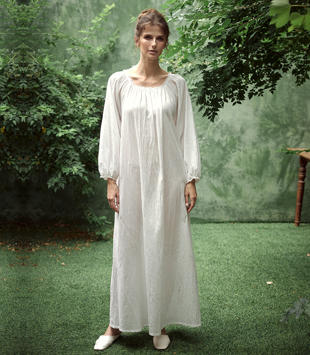 Elegant white Victorian nightgown with long sleeves and delicate lace trim