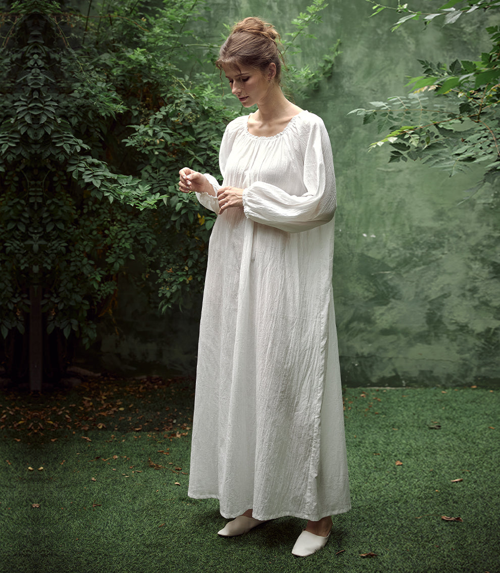 Elegant white Victorian nightgown with long sleeves and delicate lace trim