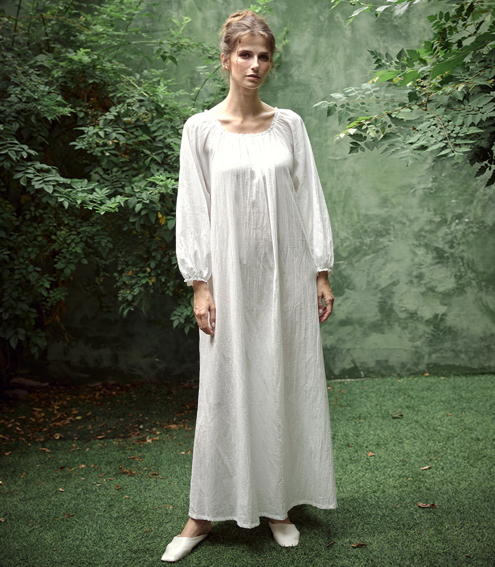 Elegant white Victorian nightgown with long sleeves and delicate lace trim