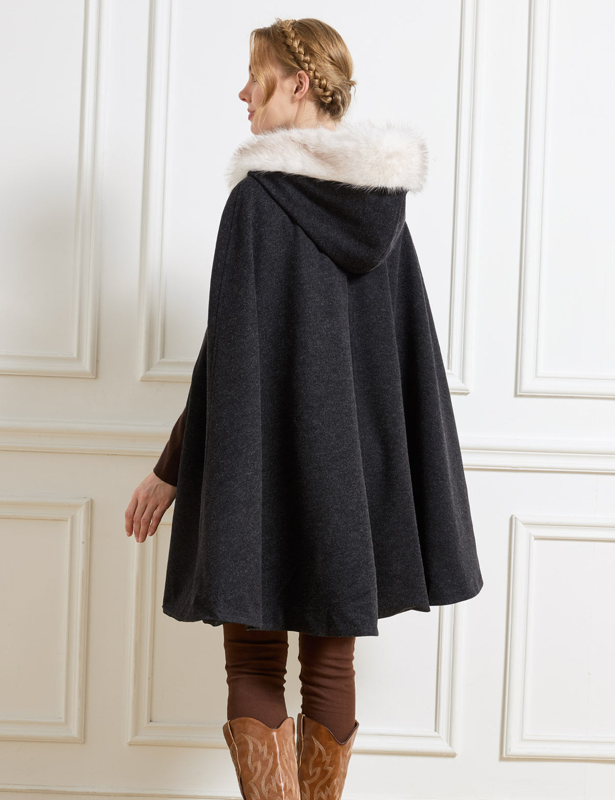 Beautelicate black vintage inspired cloak in a comfortable wool blend, highlighting a faux fur hood and a seamless deep back drape, capturing an elegant and unrestrictive old-world silhouette.
