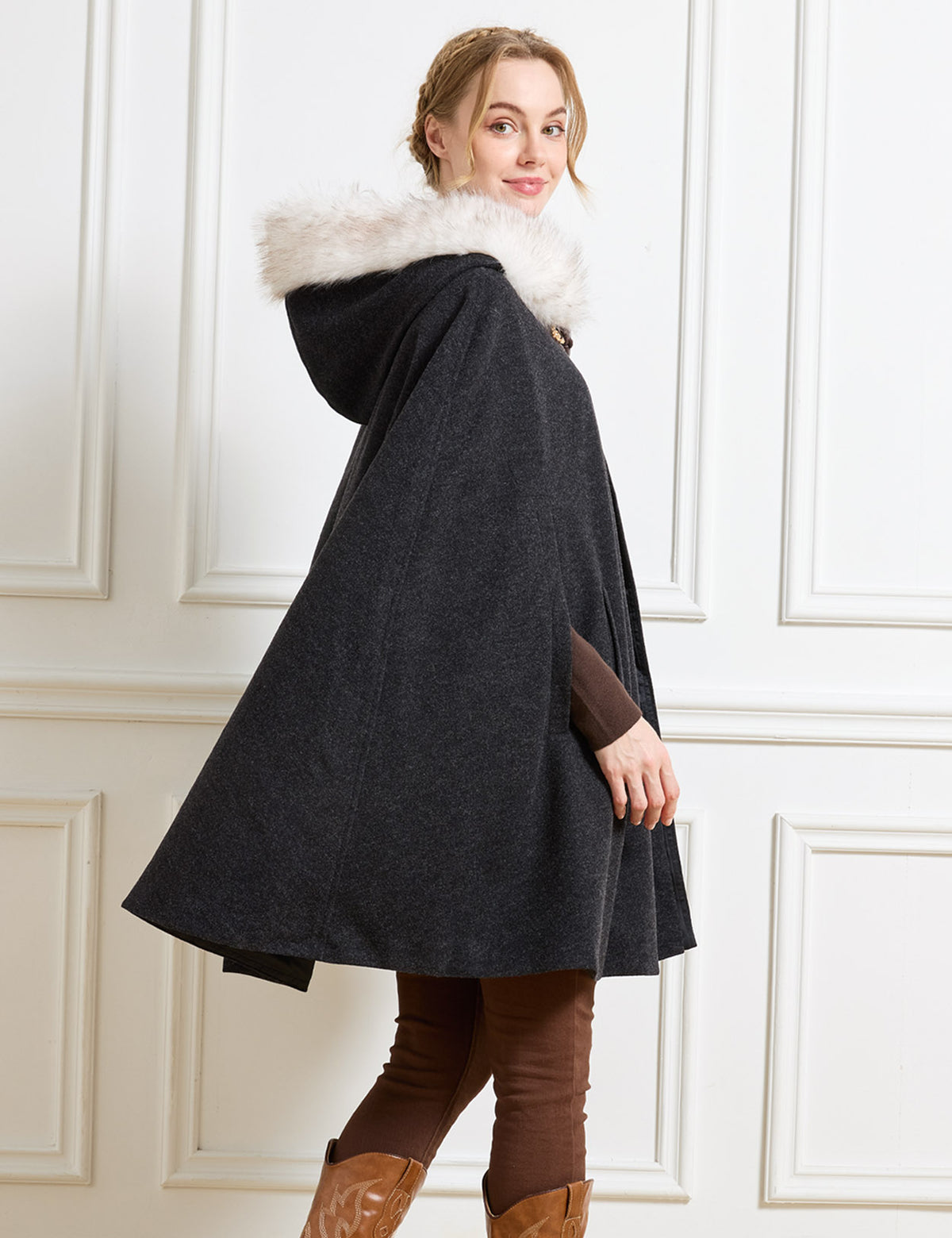 Beautelicate black vintage inspired cloak, showcasing a plush faux fur hood trim and a fluid sweeping drape, offering a comfortable and unrestrictive silhouette for a romantic winter aesthetic.