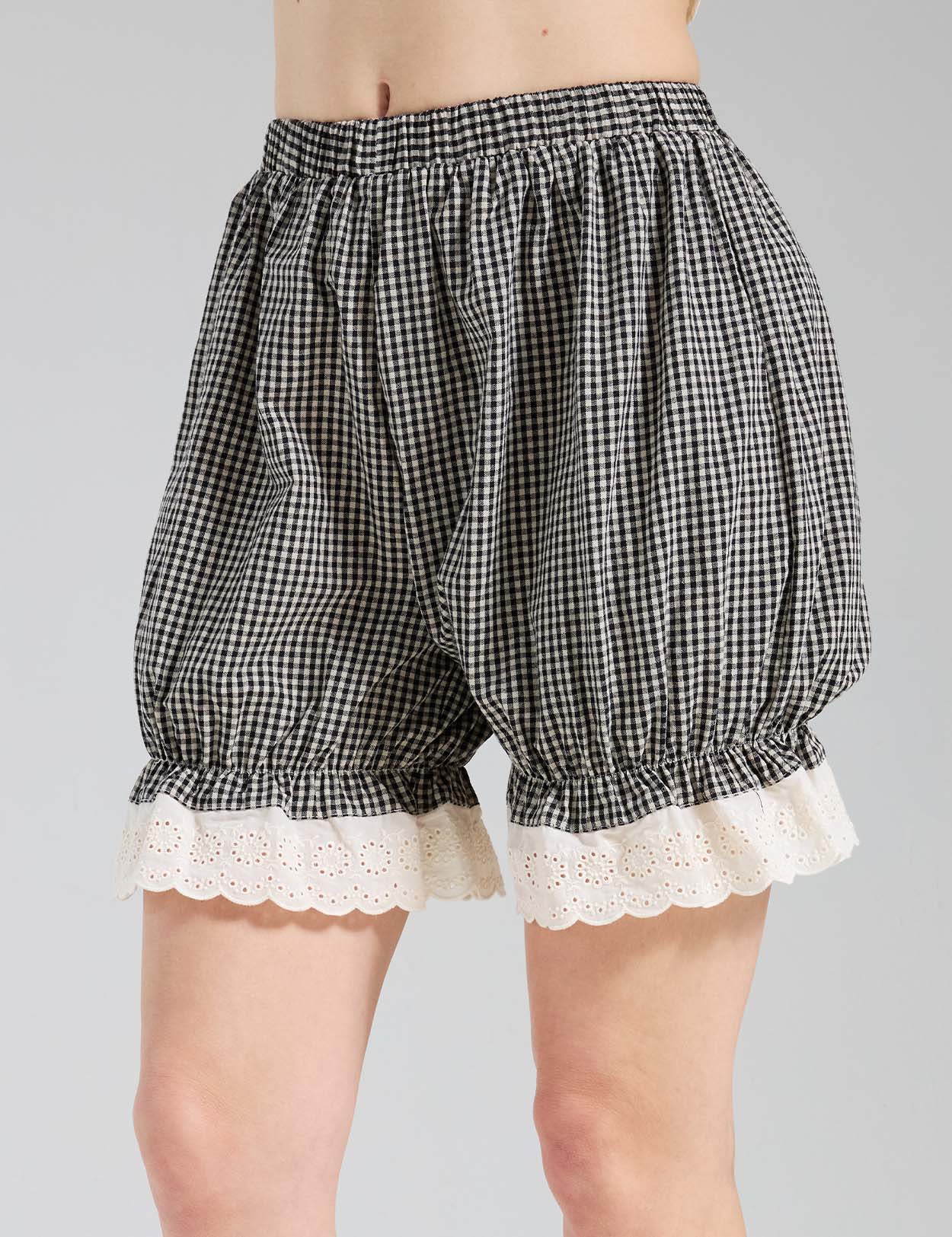 Close-up of Beautelicate gingham bloomers showing eyelet lace cuff and elastic waistband detail