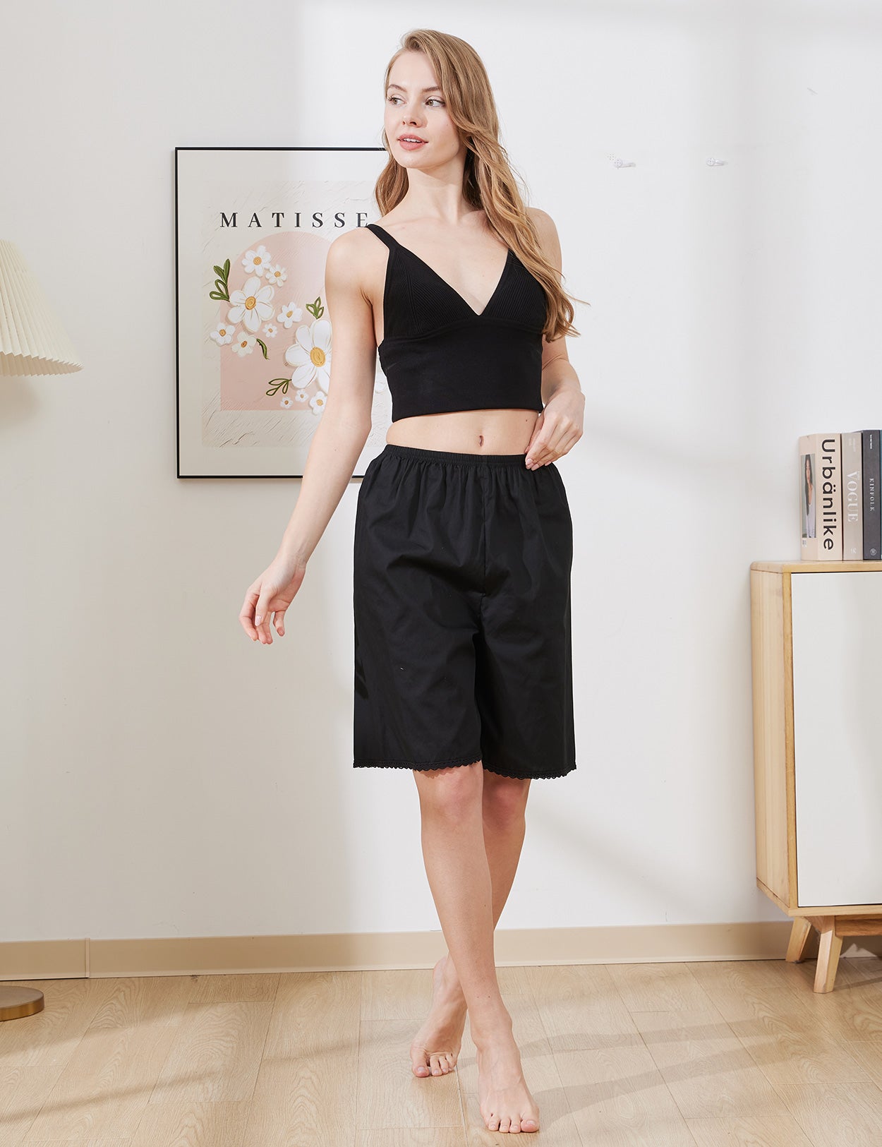 Model wearing black short cotton pettipants with lace trim, showing comfortable loose fit and knee length