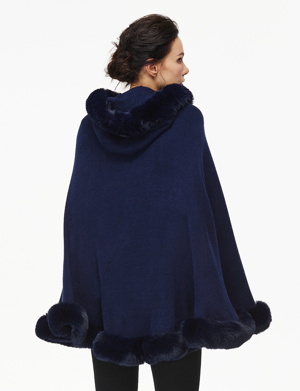 Women's faux fur poncho with hood showing elegant drape and texture