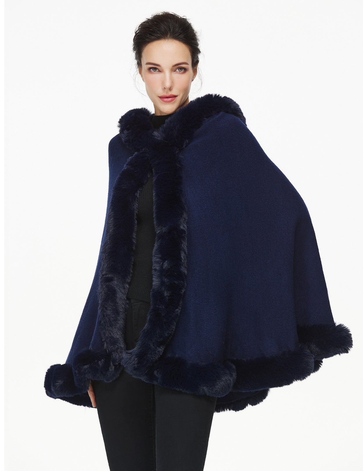 Women's faux fur poncho with hood showing elegant drape and texture