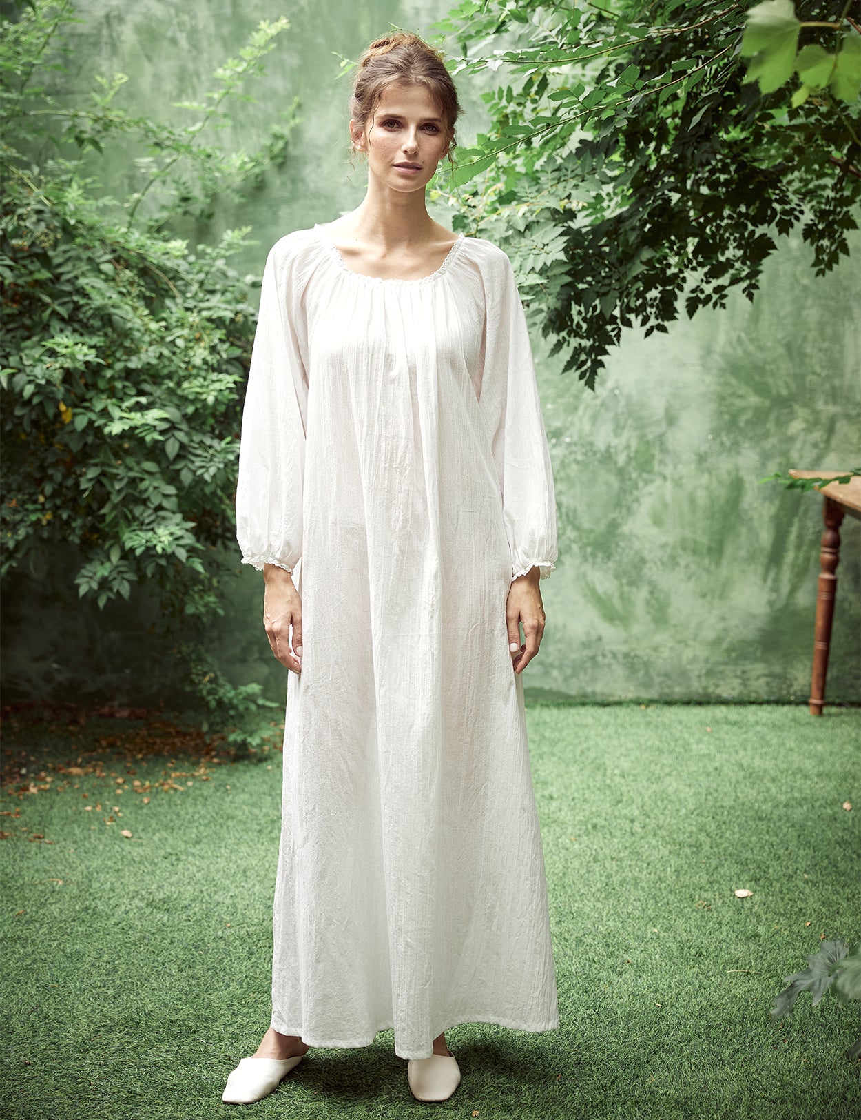 Elegant white Victorian nightgown with long sleeves and delicate lace trim