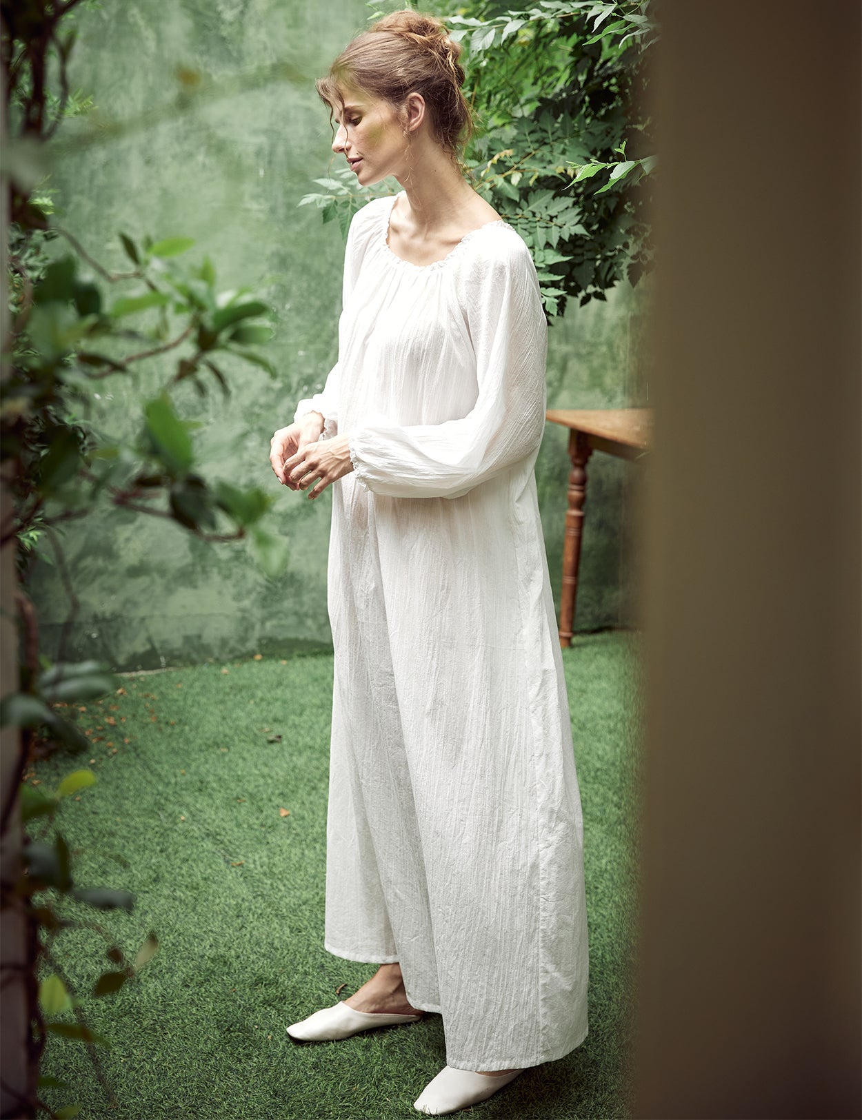 Elegant white Victorian nightgown with long sleeves and delicate lace trim