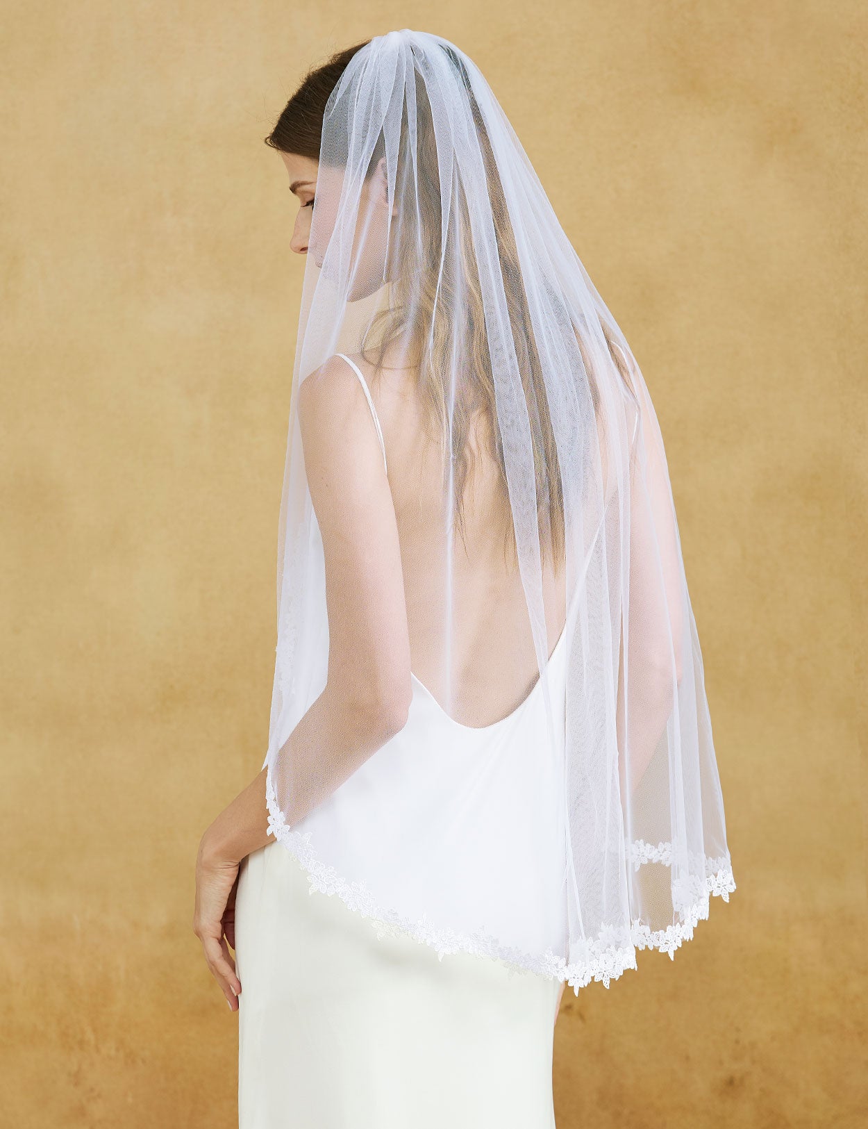Fingertip length wedding veil with delicate lace applique edge and comb