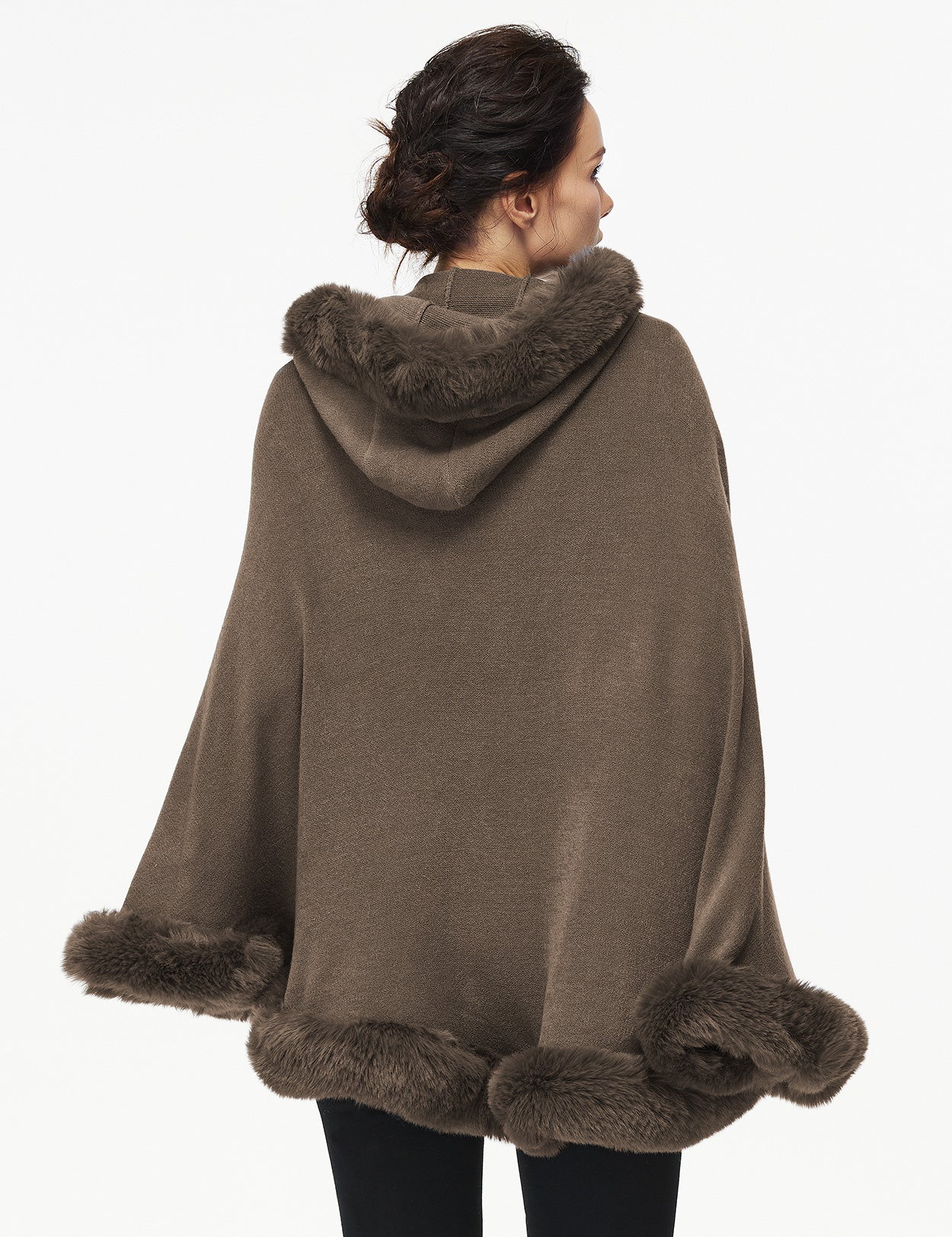 Women's faux fur poncho with hood showing elegant drape and texture