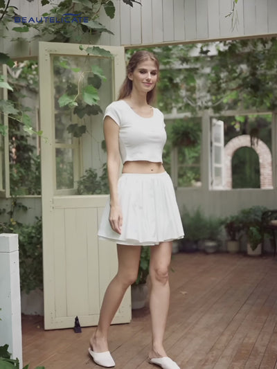 White cotton mini skirt with fluffy trim and pockets showing high-waisted A-line design