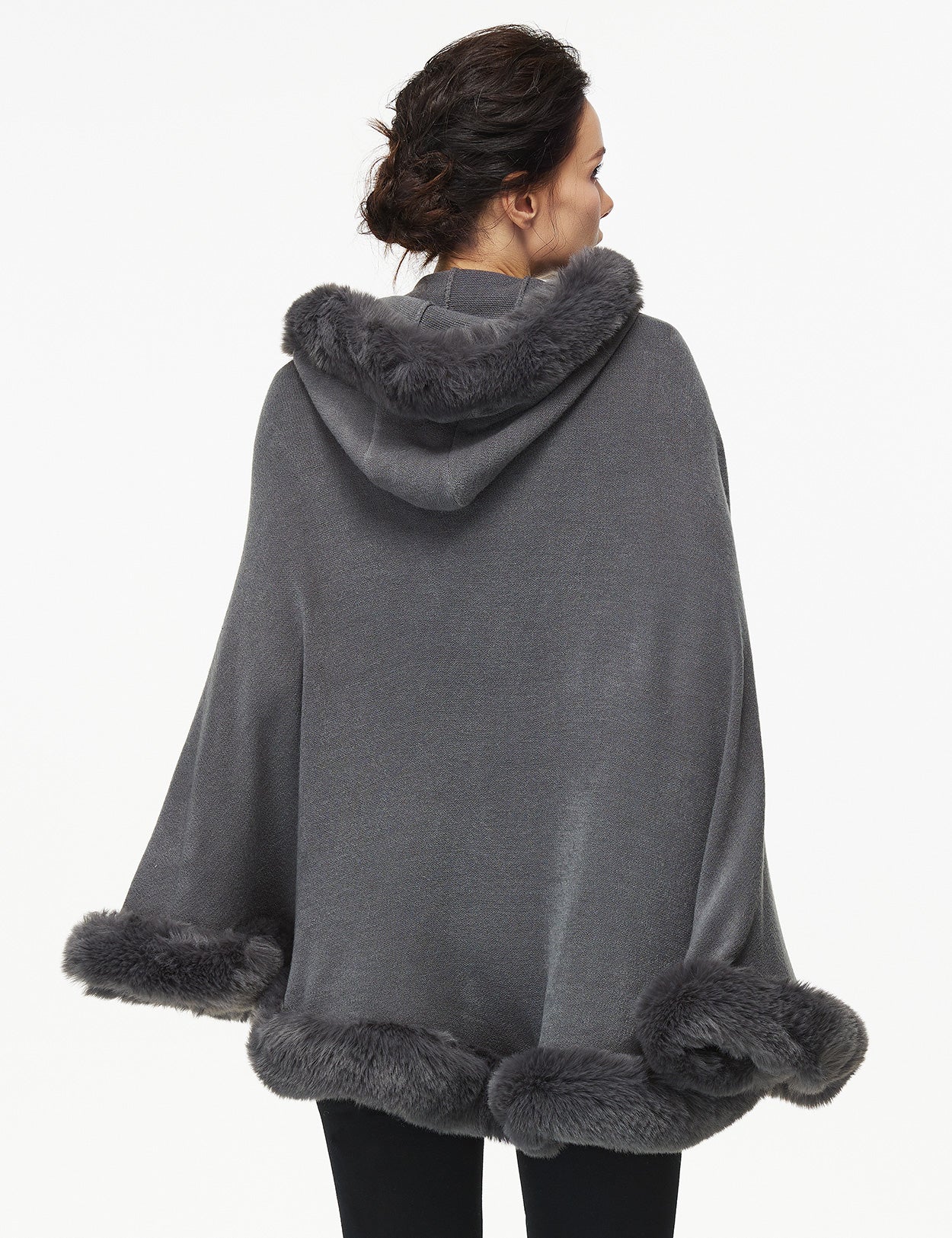 Women's faux fur poncho with hood showing elegant drape and texture