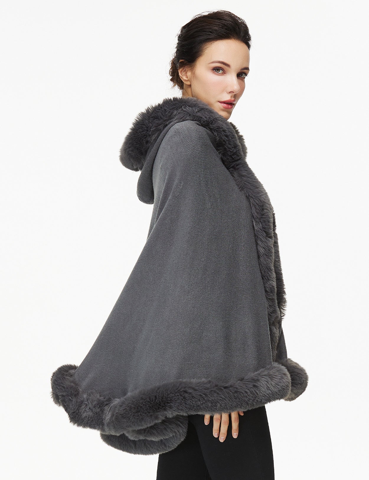 Women's faux fur poncho with hood showing elegant drape and texture