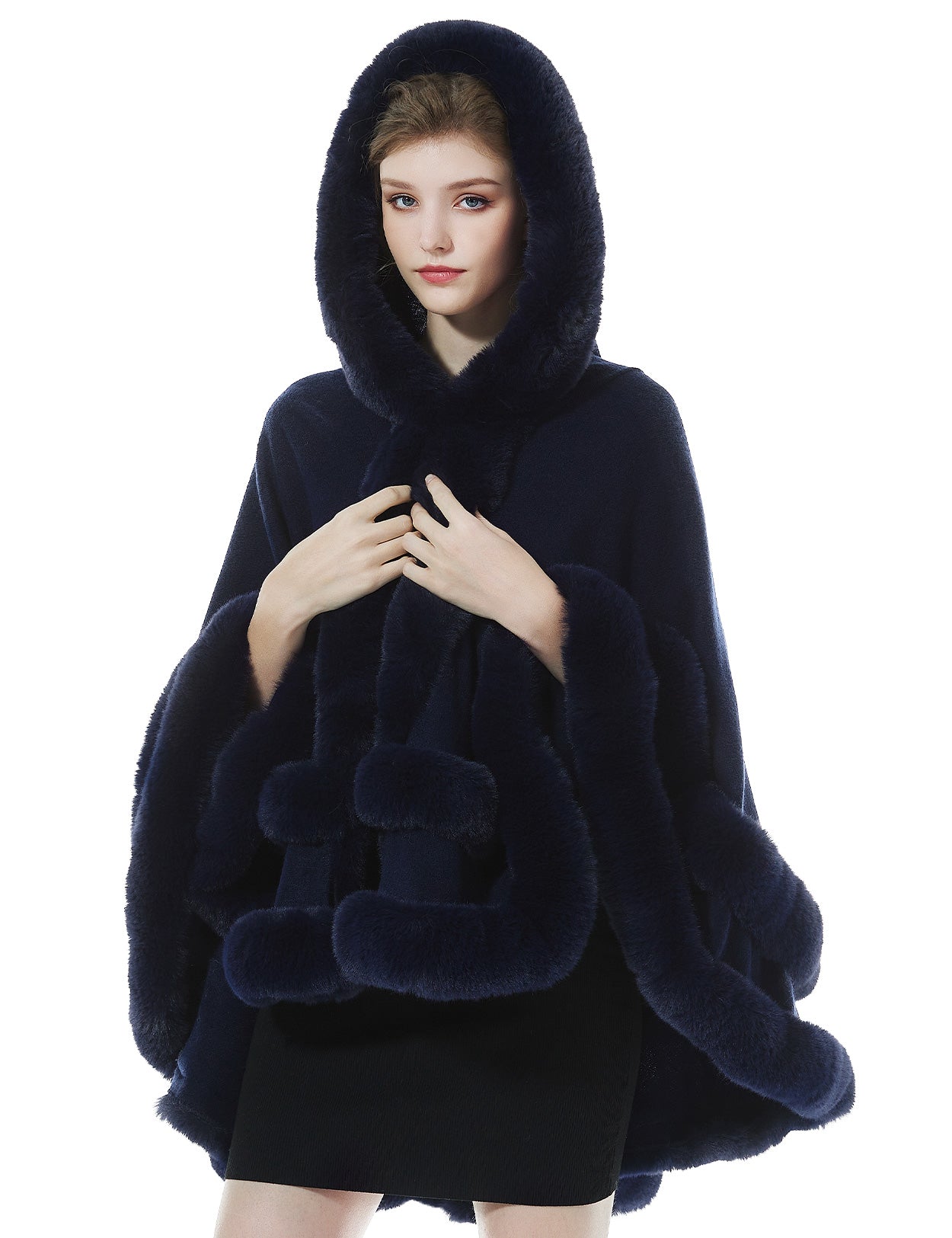 Detailed close-up of darkblue knit cape's oversized hood with luxurious faux fur lining