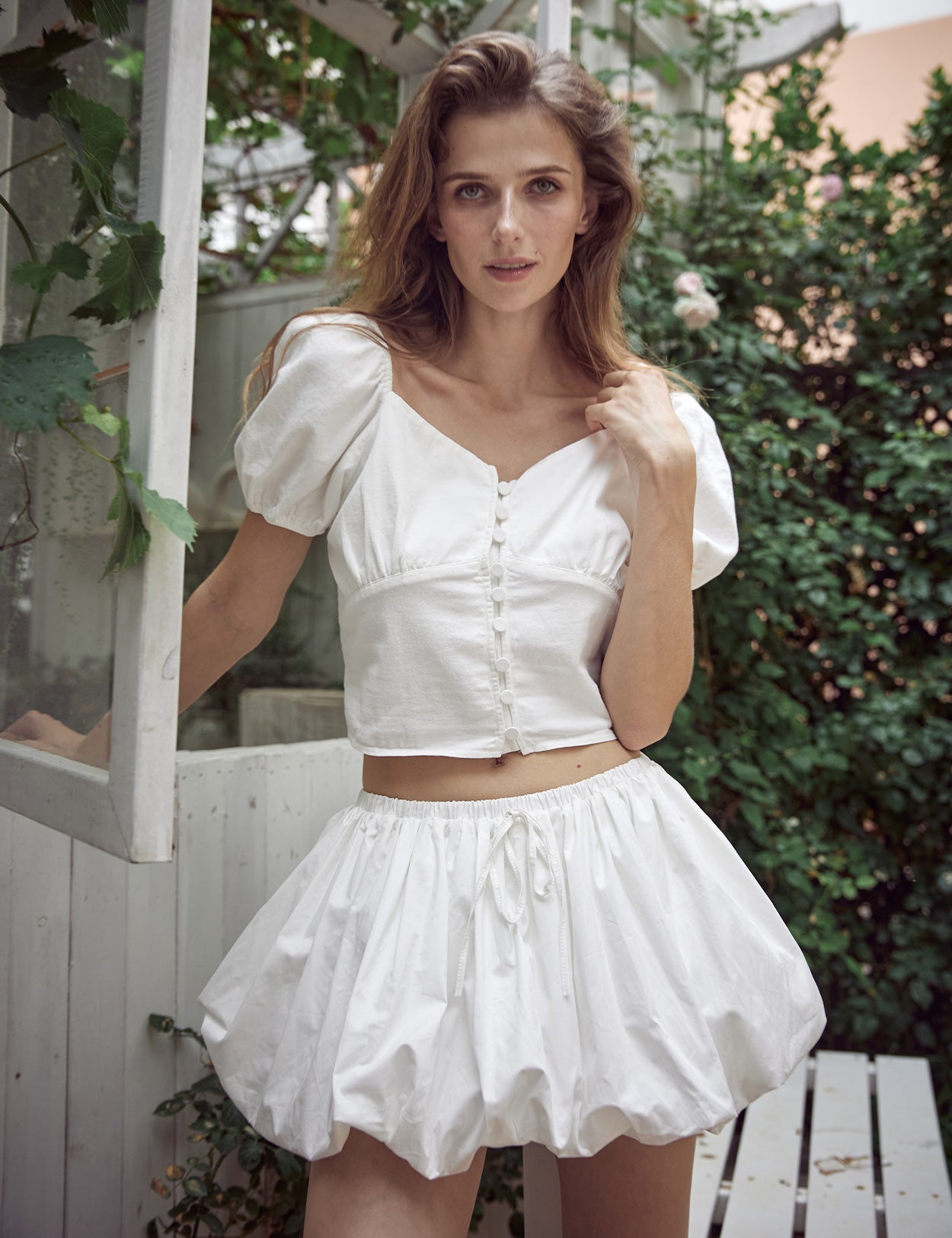 Y2K white mini bubble skirt with built-in shorts showing pleated design and streetwear style